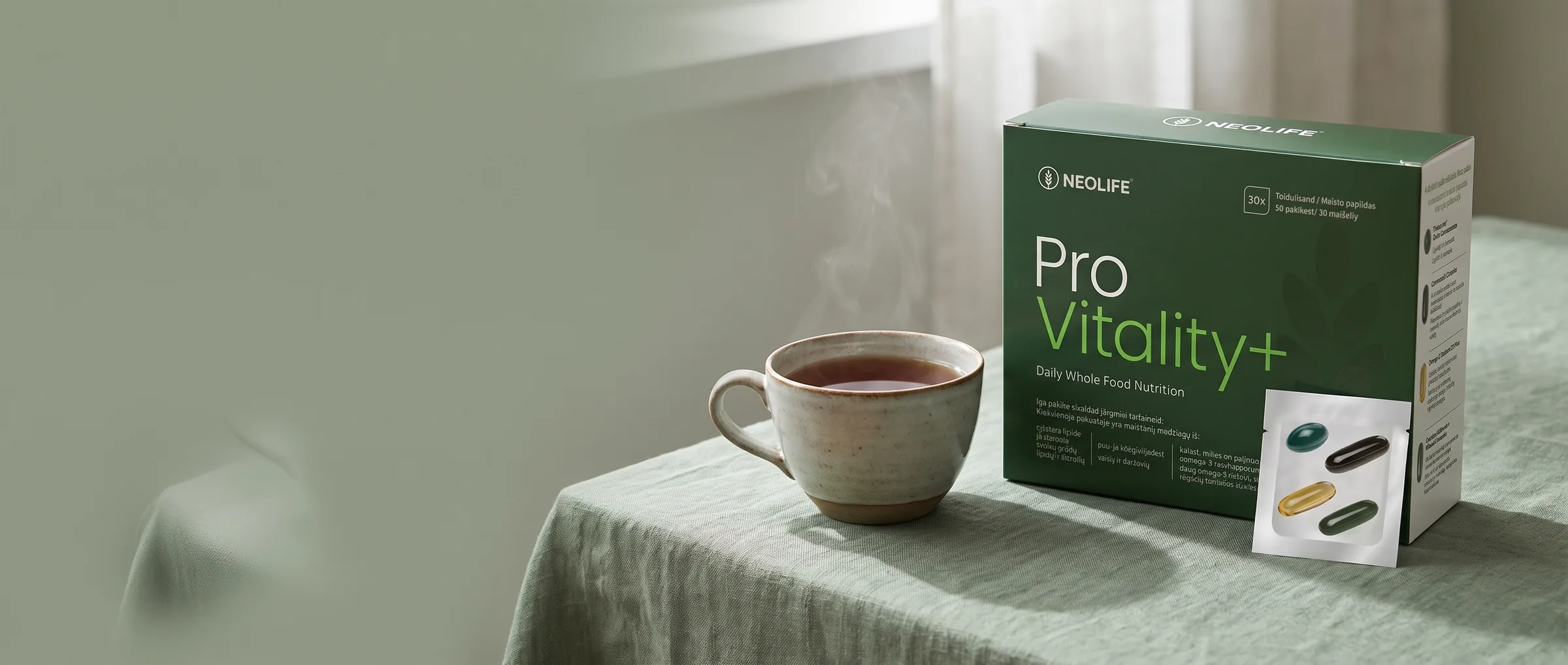 NeoLife Pro Vitality+ box on a linen table with a cup of tea